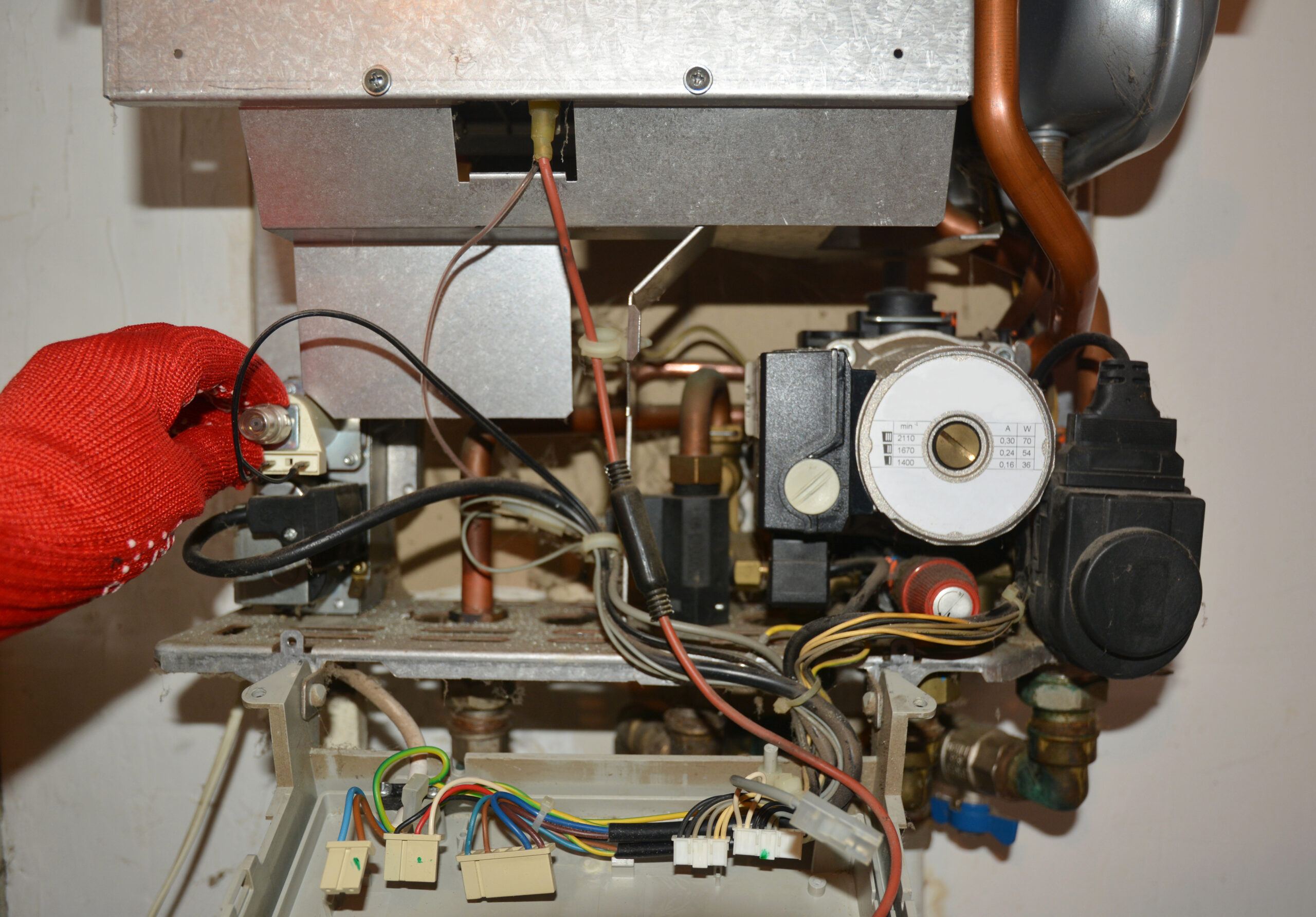 HVAC technician tuning a gas boiler